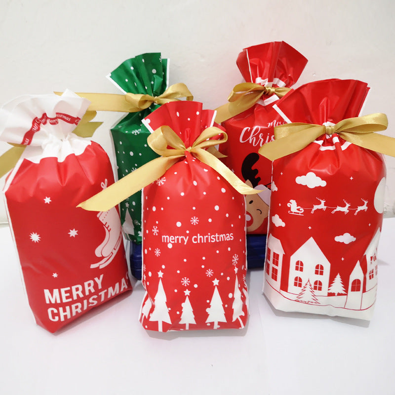 Five festive gift bags in red and green, decorated with Christmas motifs like trees, snowflakes, and reindeer, each tied with gold ribbons, displayed against a white background.