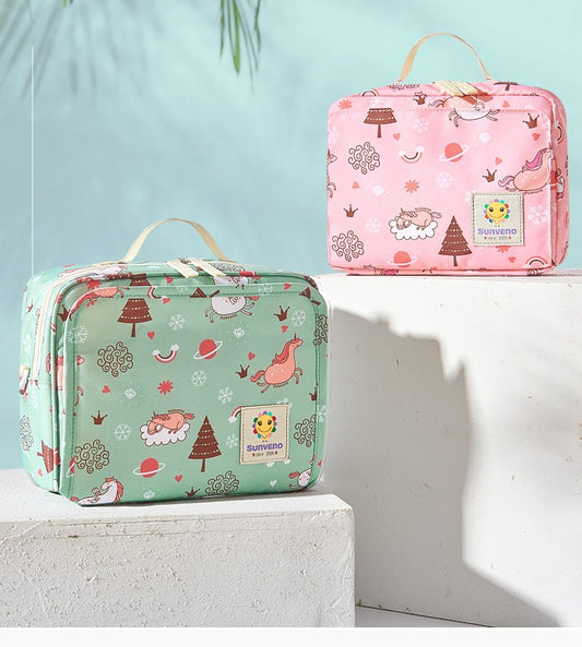 Two colorful lunch bags with playful patterns on a white surface. One is mint green, the other pink, both featuring whimsical designs of unicorns, trees, and birds.