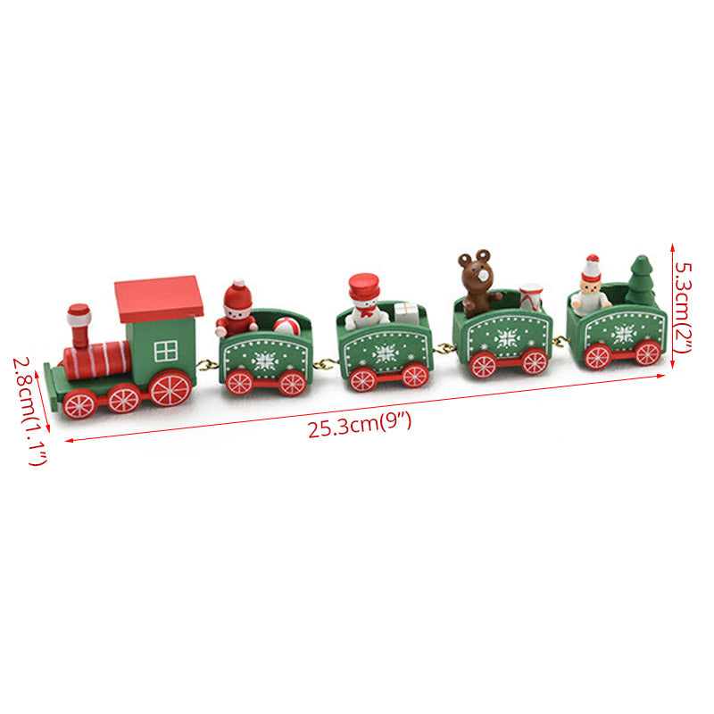 Miniature Christmas train set with four green cars featuring festive figures, including Santa and a reindeer, connected by gold hooks. Dimensions shown: 25.3cm length, 5.3cm height.