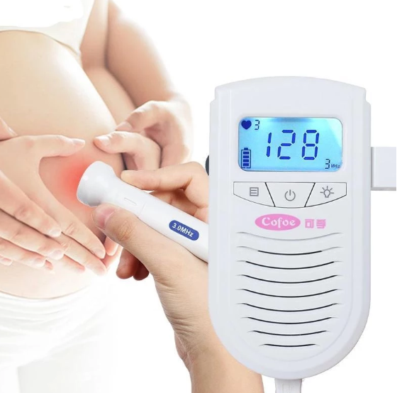 Hand holding a fetal doppler device against a pregnant belly, displaying a heart rate of 128 BPM. The screen shows battery and signal strength indicators.