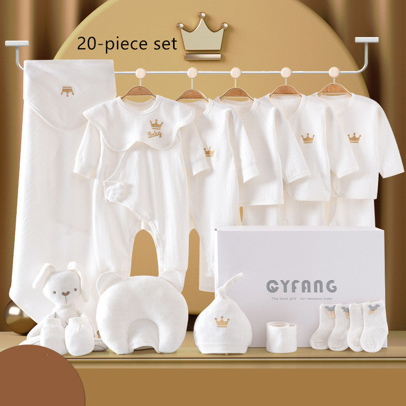 Baby clothing set includes onesies, cardigans, and accessories in white with gold crowns. Displayed with a plush toy, pillow, hat, socks, and packaging box labeled "CYFANG."