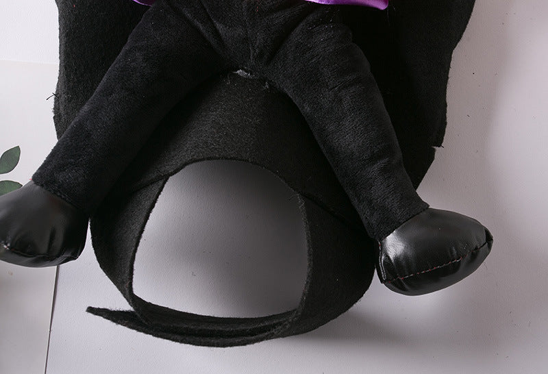 Close-up of a black velvet costume with shiny black mittens and legs on a white background, resembling an animal outfit. Two green leaves are visible in the corner.