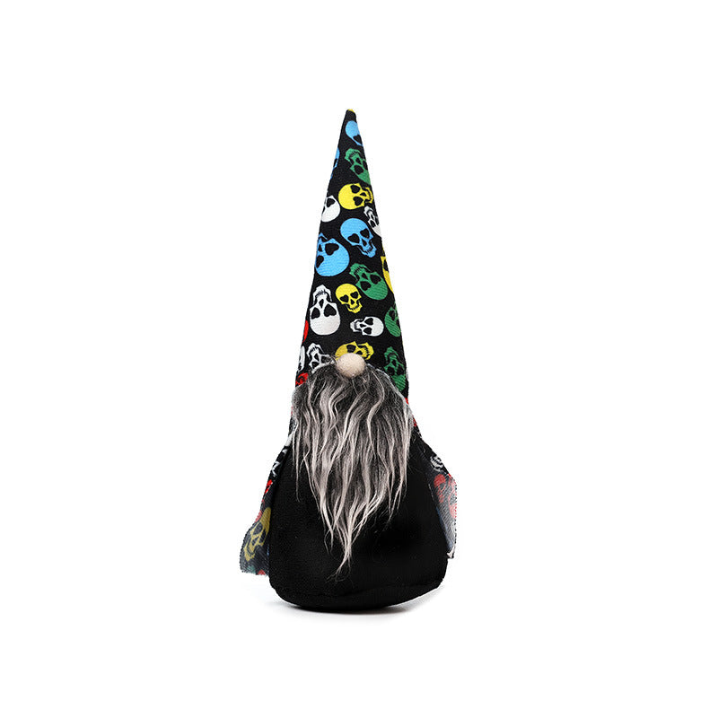 A decorative gnome with a tall, pointed hat featuring a vibrant skull pattern in blue, yellow, green, and red on a black background. The gnome has a long gray beard and a round, wooden nose. It stands upright against a plain white background.