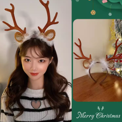 Woman wearing reindeer antler headband with a fluffy white trim next to a photo of the headband on a table. Background features festive Christmas decorations.