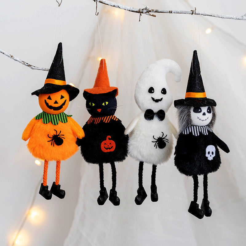 Four Halloween plush ornaments hang: a pumpkin, black cat, ghost, and skeleton, each with hats and themed decorations, against a softly lit white background.