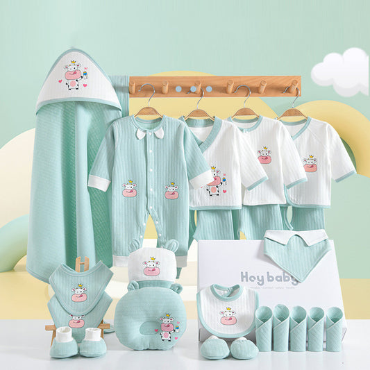 Baby clothing set in pastel green and white, featuring a cow design. Items include a romper, shirts, hats, pants, bibs, mittens, and a hooded towel, neatly displayed on hangers.