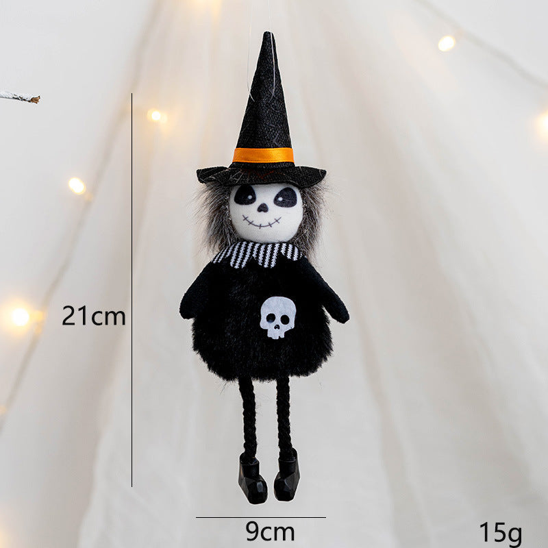 Plush witch doll with black outfit, skull design, striped scarf, and orange-banded hat. Measures 21cm tall, 9cm wide, and weighs 15g. Soft lighting in the background.