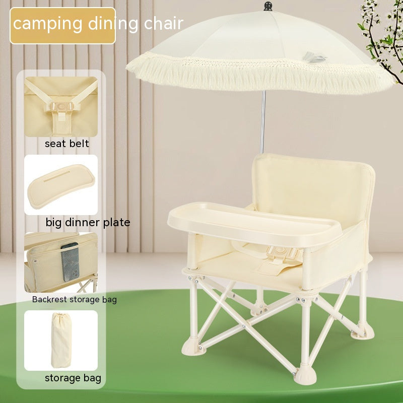 Beige camping dining chair with a large dinner tray, seat belt, backrest storage, and detachable umbrella on a green surface. Features inset images of the chair's components.
