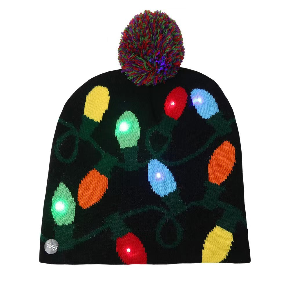 Black knitted beanie with colorful LED Christmas lights design and a multicolored pom-pom on top. “On/Off” button visible on the brim.