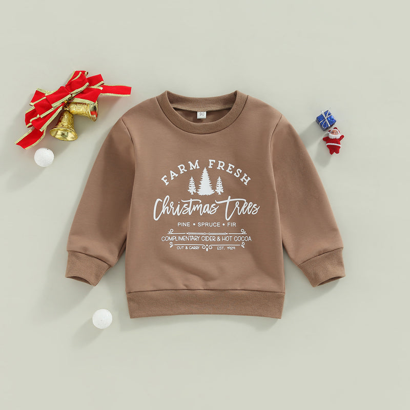 Brown children's sweatshirt with "Farm Fresh Christmas Trees" print, surrounded by holiday decorations like bells with a red bow, small gifts, and festive ornaments.
