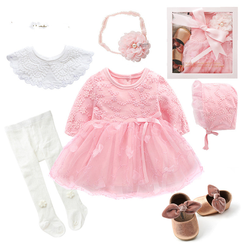Baby girl outfit set with pink lace dress, matching bonnet, headband, and bow shoes. Includes white tights and a decorative collar, all neatly presented in a pink gift box.