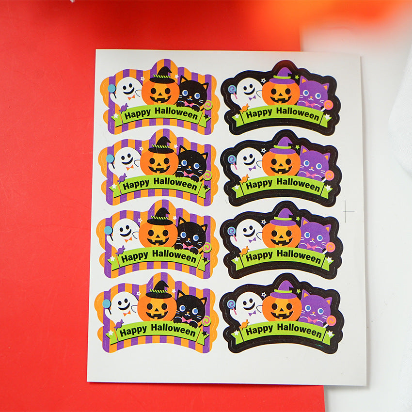 A sheet of colorful Halloween stickers featuring ghosts, pumpkins, cats, and bats. The stickers have festive designs with "Happy Halloween" text on a cartoon striped and scalloped background, some with hats or stars, on a bright red surface.