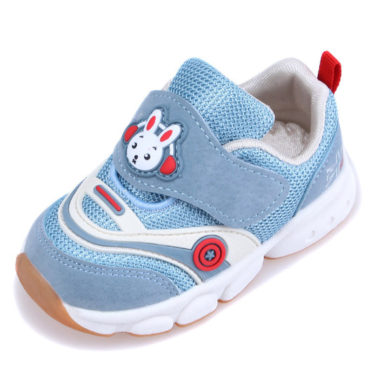 Blue and white children's sneaker with a bunny design on the Velcro strap, red accents, and a non-slip sole. Features contrast stitching and a red loop on the heel.