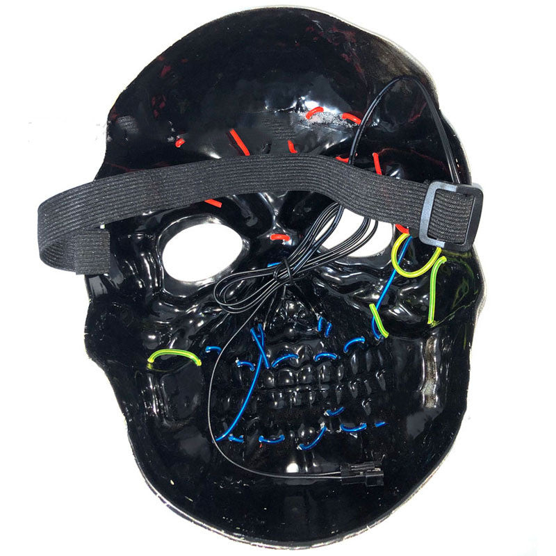 A black skull mask with colorful wires and an attached strap. The mask features red, blue, and green stitched details and has a cable for LED lighting.