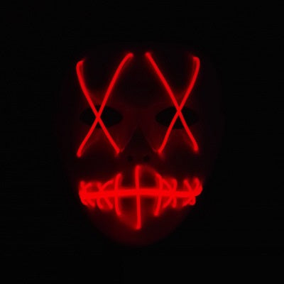A dark face mask with glowing red LED lights in an 'X' shape over the eyes and stitched-like pattern over the mouth, set against a black background.