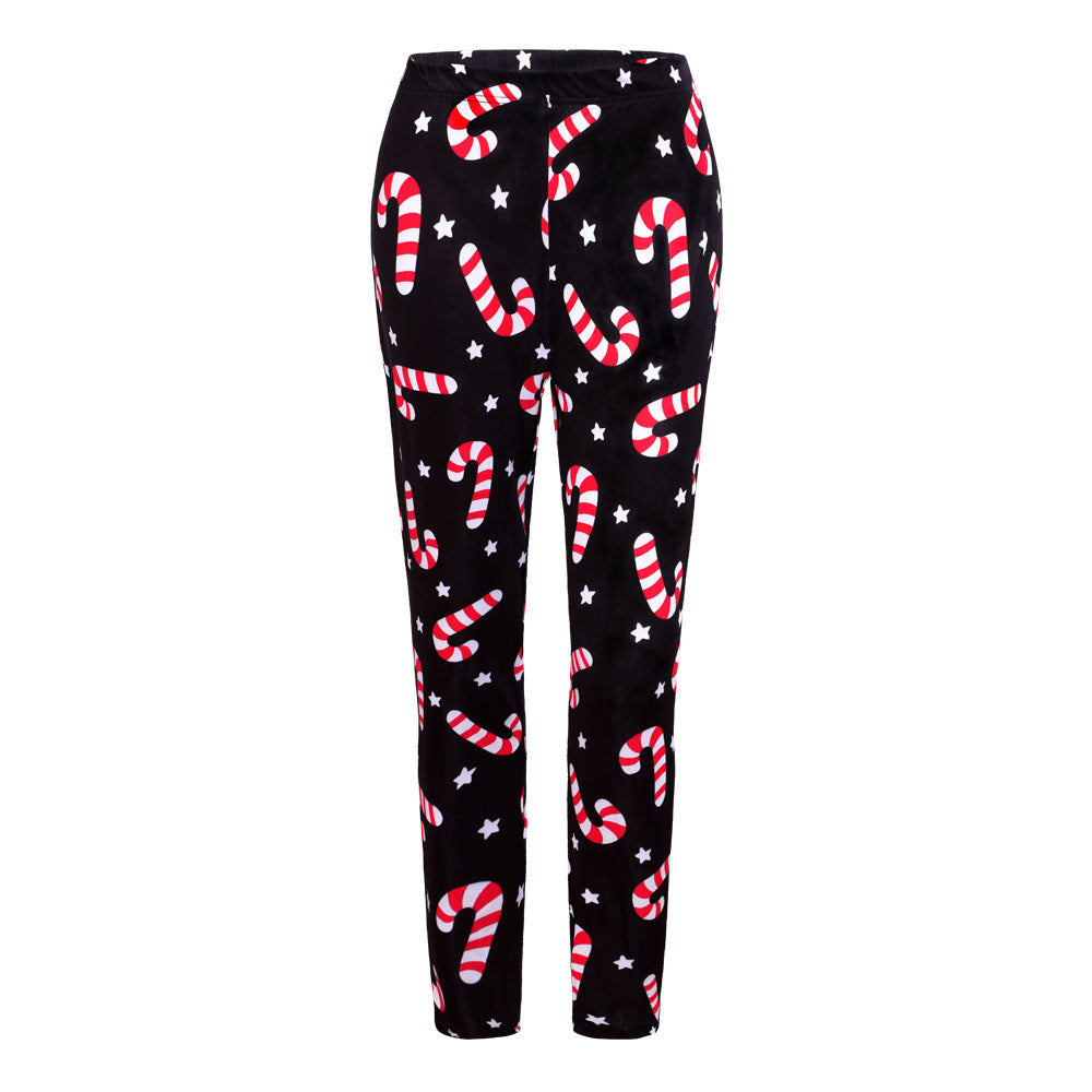 Black pants featuring a playful pattern of red and white candy canes and white stars, creating a festive holiday look.