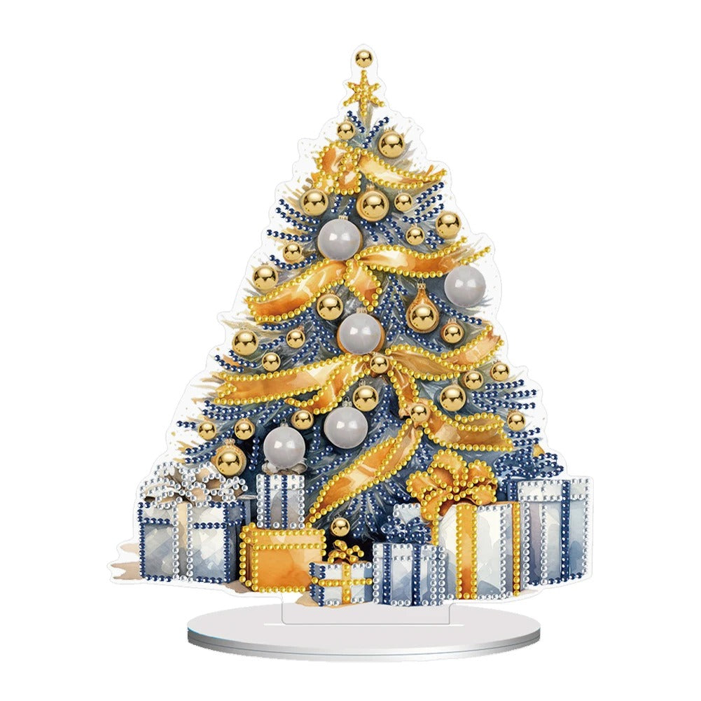 Festive Christmas tree adorned with gold and silver ornaments, ribbons, and baubles. Presents wrapped in blue and gold sit underneath on a circular base.