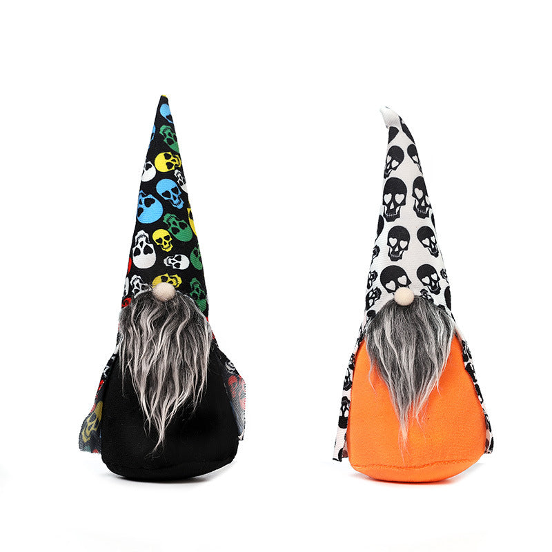 Two plush gnomes with long gray beards and pointed hats. The left gnome has a black body and a hat with colorful skulls, while the right gnome has an orange body and a hat with black and white skulls. Both feature round wooden noses and minimalistic, whimsical designs against a white background.