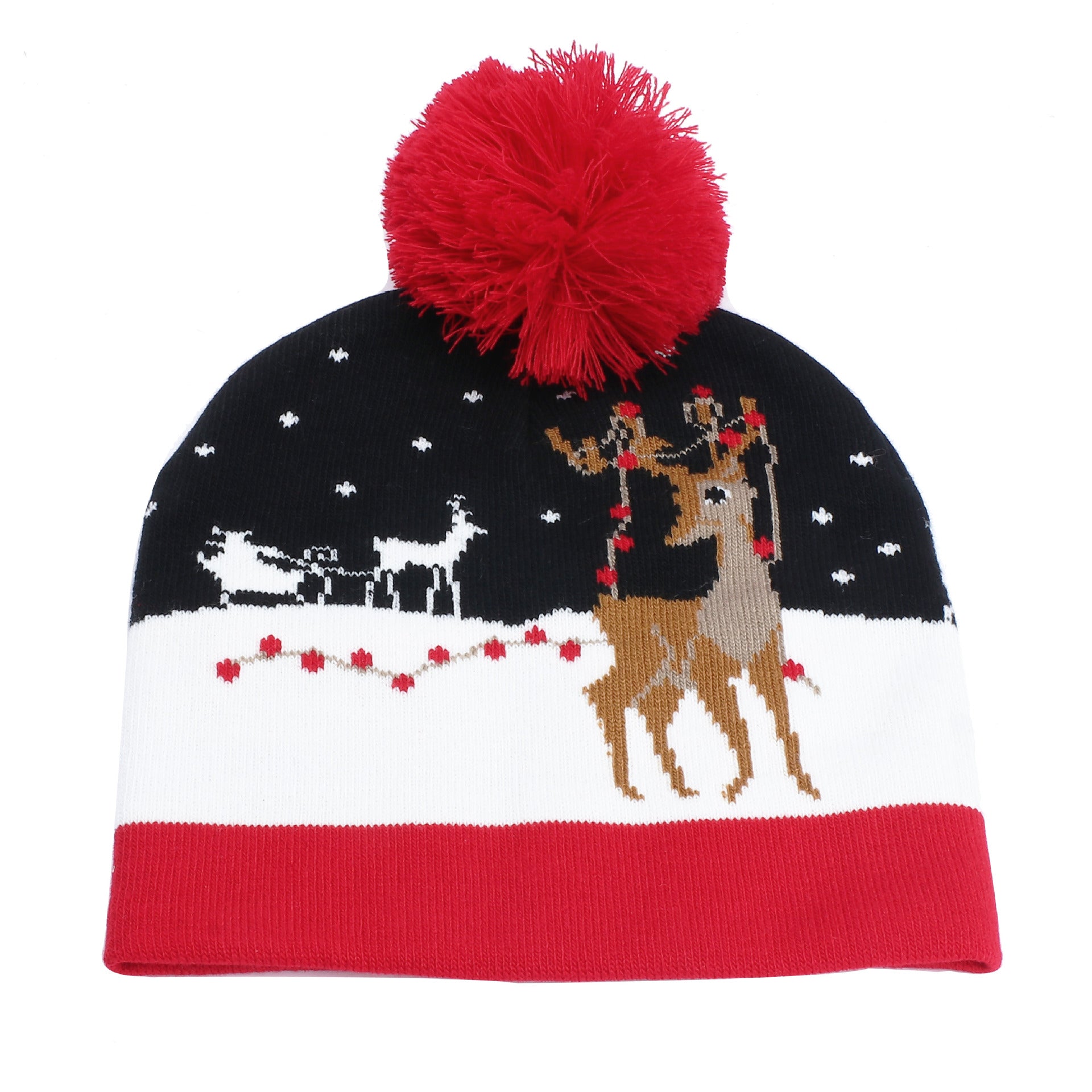 A winter beanie with a red pom-pom, featuring a snowy scene with reindeer and a sleigh in red and white on a black background, and a red border at the bottom.