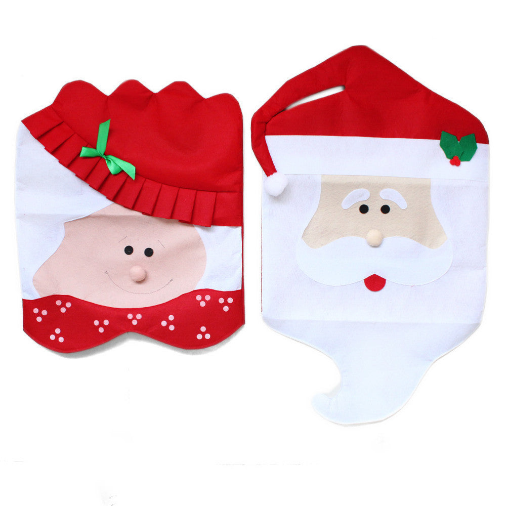Two fabric holiday bags shaped like Mrs. Claus and Santa Claus. Mrs. Claus wears a red hat with a green bow, and Santa has a red hat with a holly detail.