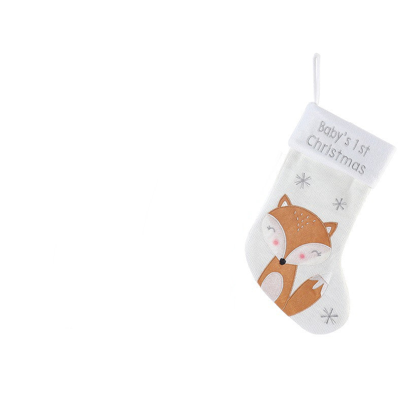 White Christmas stocking with "Baby's 1st Christmas" text, features a cute fox and snowflake design. Stocking is isolated on a white background, hanging by a loop.