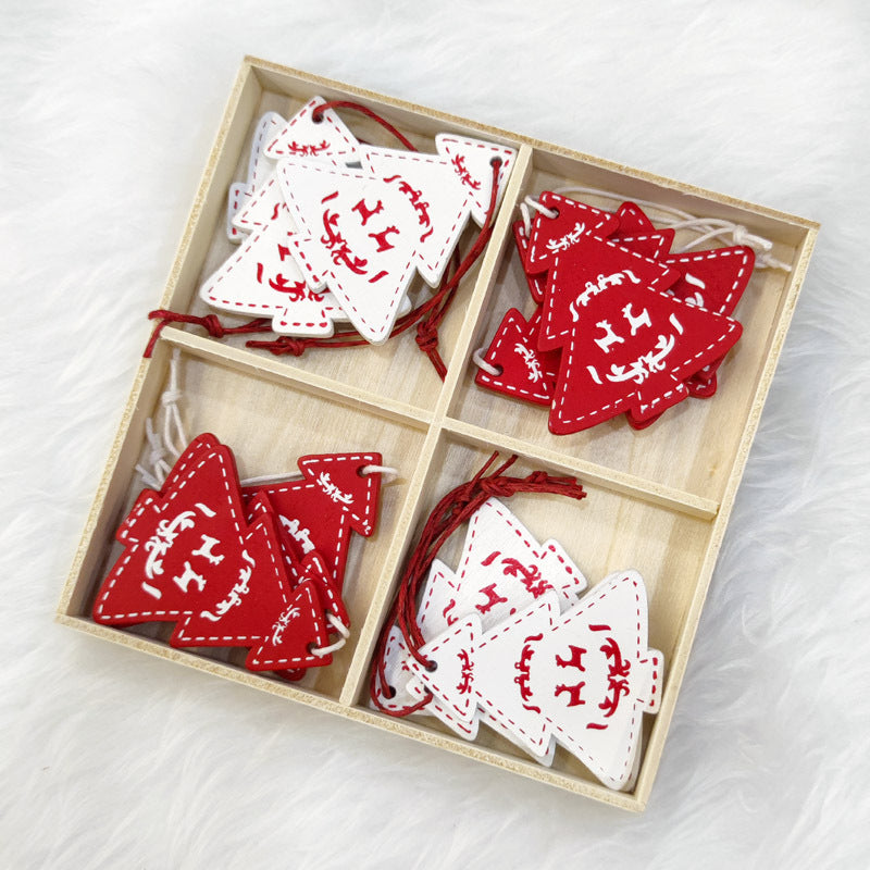 Wooden box with four compartments holding red and white felt Christmas tree ornaments, each featuring a reindeer design. The ornaments have decorative stitching.