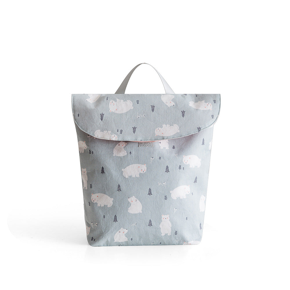 Light gray backpack featuring a playful pattern of white polar bears and small trees. The backpack has a simple, flap-top design with a single handle for easy carrying.