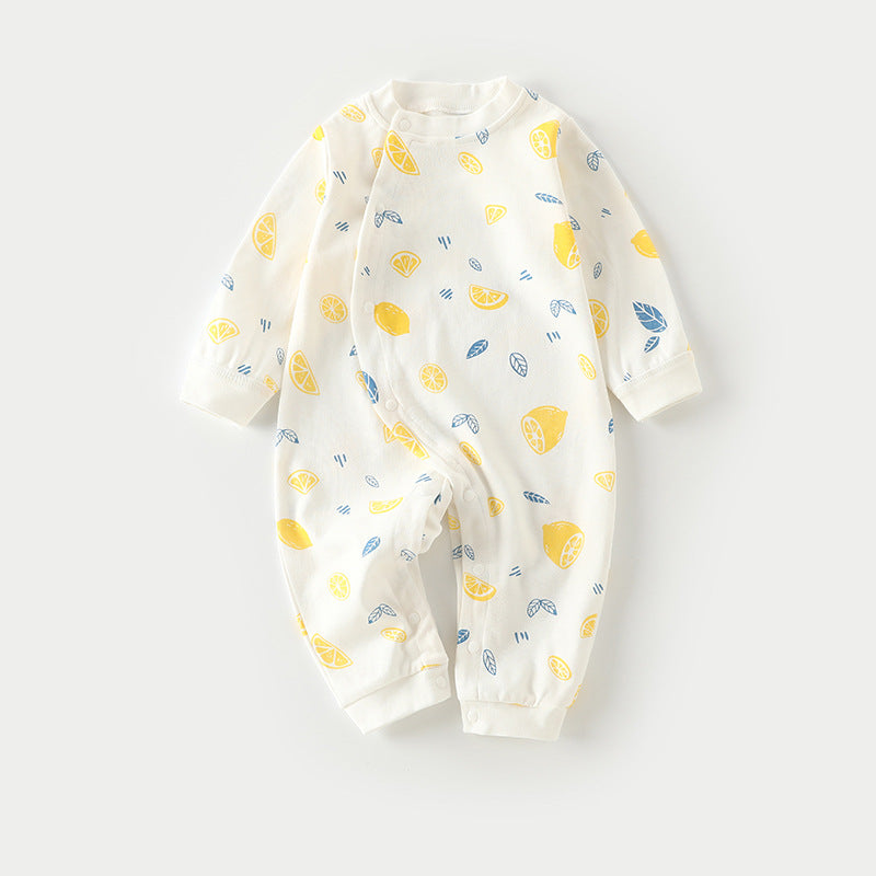 White baby romper adorned with yellow lemon and blue leaf patterns. Long sleeves and snaps along the front and bottom for easy dressing.