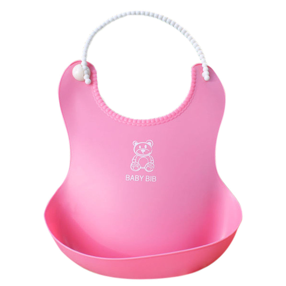Pink silicone baby bib with a curved lip to catch spills. Features a bear design and the words "BABY BIB" printed below. Adjustable strap with white beads for fastening.