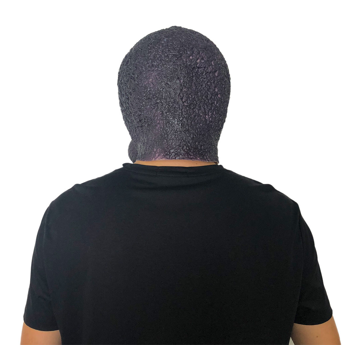 Back view of a person wearing a textured, dark-colored full-head mask and a black t-shirt, with a white background.