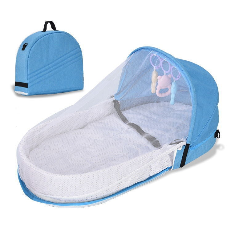 Blue portable baby bed with a mesh canopy and attached toy bar, featuring plush toys. Comes with a matching blue carrying case. Ideal for travel and outdoor use.