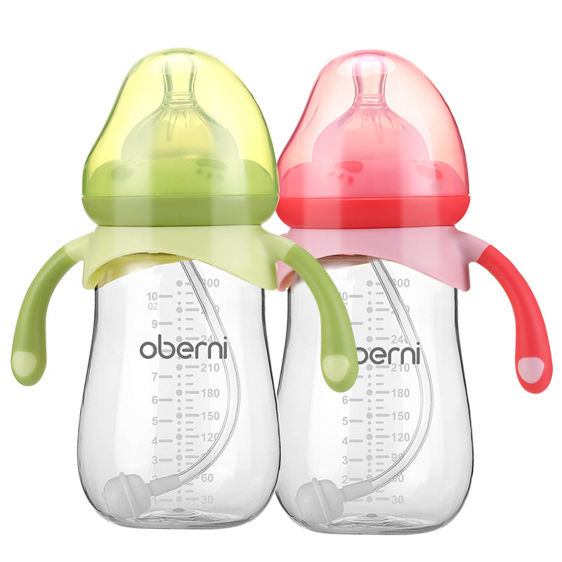 Two baby bottles with measurement markings and handles. One has a green lid and handles, the other pink. Both have clear silicone nipples and straws inside.