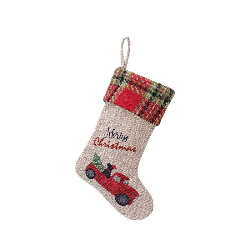 Beige Christmas stocking with a plaid top, featuring "Merry Christmas" text and an embroidered red truck with a Christmas tree.