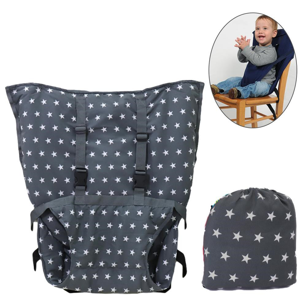 Gray star-patterned portable high chair harness shown unfolded, with a smaller inset image of a child seated safely in it. Includes a matching drawstring bag for storage.