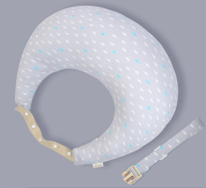 Gray nursing pillow with small white and blue raindrop patterns, featuring a tan strap with white buttons and an additional matching strap with a plastic buckle, on a solid background.