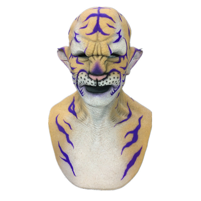 Person wearing a tiger-inspired latex mask featuring yellow skin, purple stripes, and prominent facial features, including a detailed nose and mouth, with feline ears and markings.