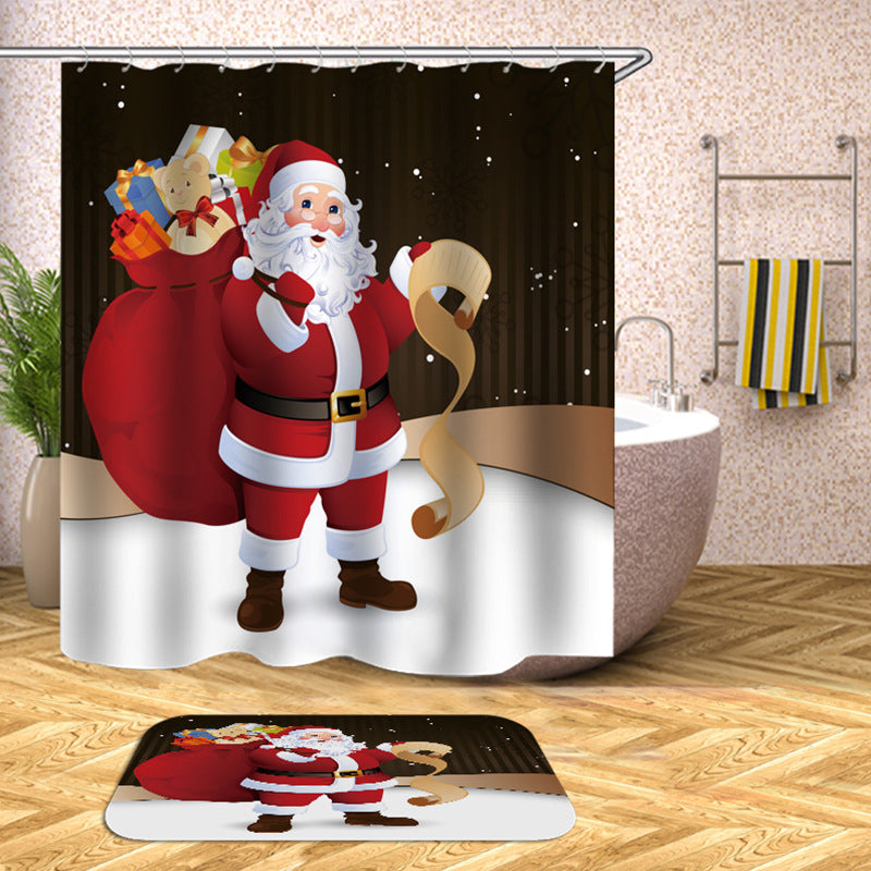 Shower curtain with Santa Claus holding a scroll, carrying a red sack of gifts, set in a snowy scene. Matching bath mat and yellow-striped towel are visible in the bathroom.