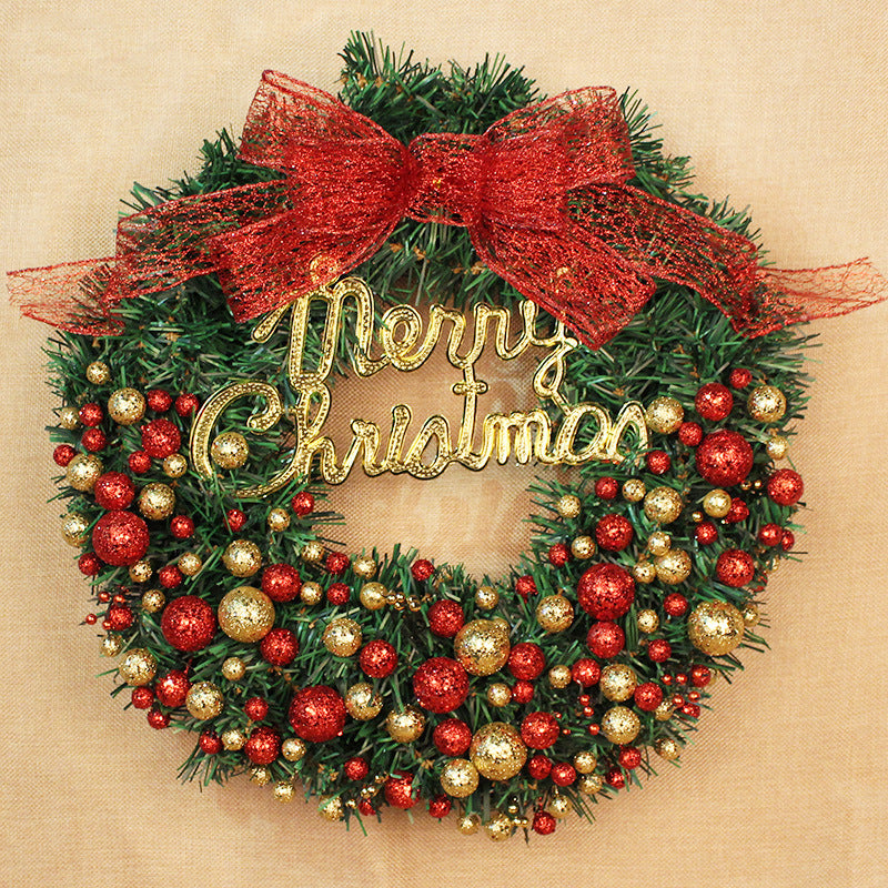Christmas wreath decorated with red and gold baubles, featuring a large red bow at the top and the words "Merry Christmas" in gold across the center.