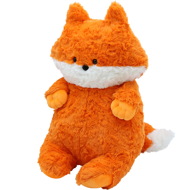 A fluffy orange plush fox toy with a white belly and snout, black eyes, and a small black nose. It sits upright with its tail visible, featuring white tips on its ears and tail.