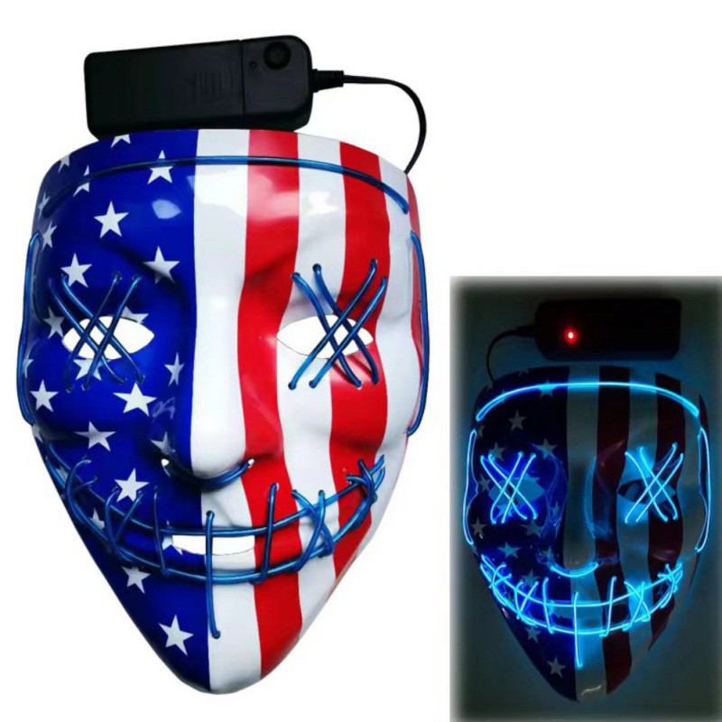 Mask with U.S. flag design and blue LED wires forming a stitched smile and X-shaped eyes. Battery pack attached. Lit version shows mask glowing with an eerie blue light.
