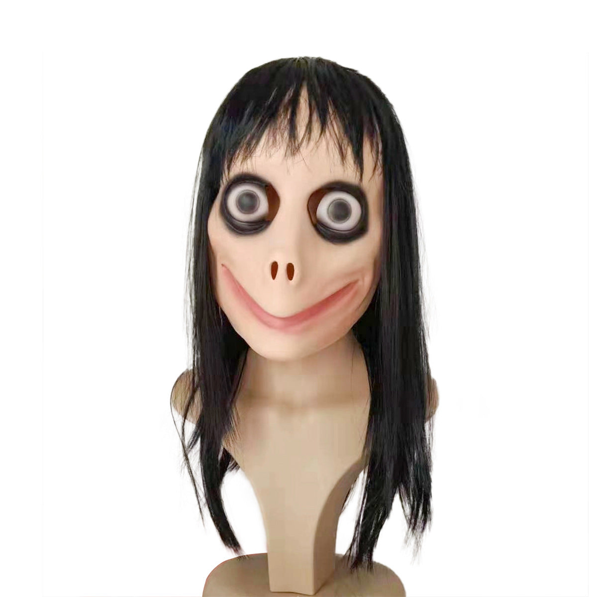 Creepy doll head with exaggerated eyes, wide smile, and long black hair. The skin is pale, and there are dark circles around the eyes, mounted on a beige stand.