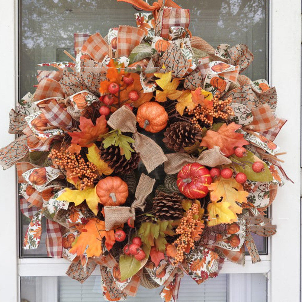 Festive autumn wreath with pumpkins, pine cones, berries, and colorful leaves. It features plaid and burlap ribbons, creating a vibrant and rustic seasonal decoration.