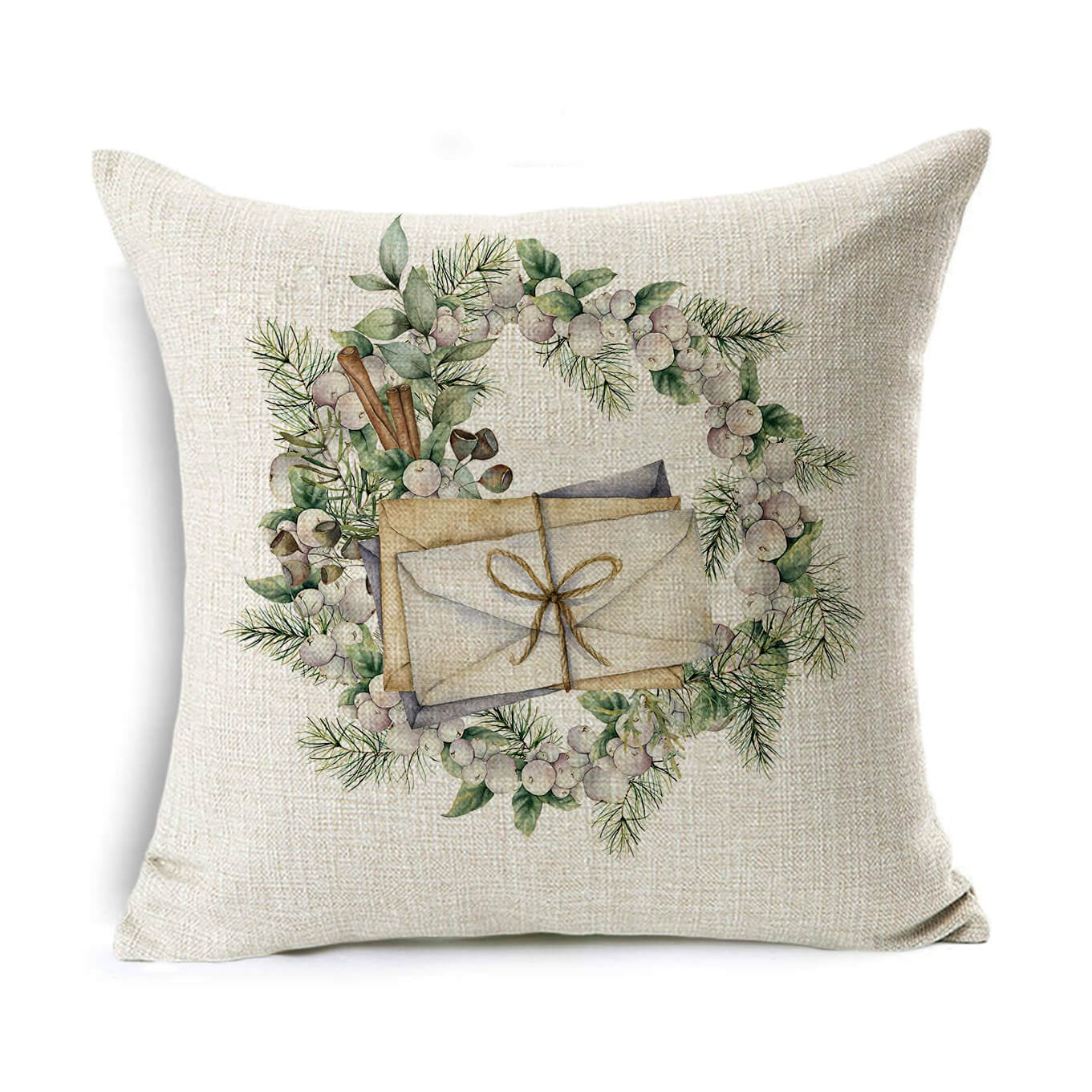 Decorative pillow with a wreath of leaves and berries, featuring an envelope tied with string in the center. The background is a light, textured fabric.