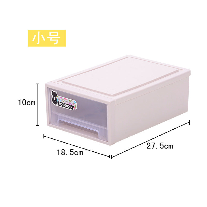 Small, rectangular, cream-colored plastic storage box with a transparent drawer. Dimensions: 10cm height, 18.5cm width, 27.5cm depth. Label with black cat icon on front.