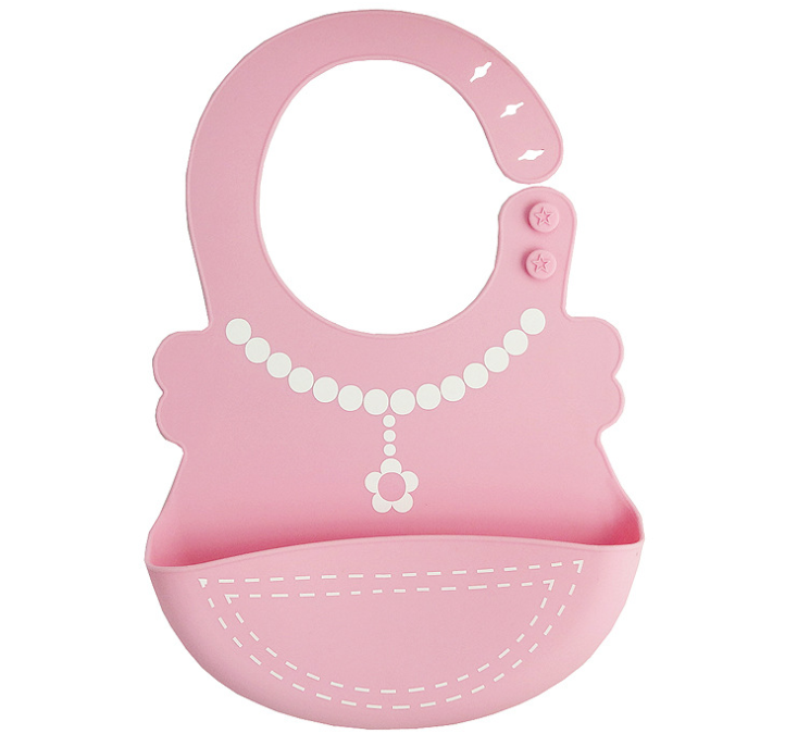 Pink silicone baby bib with a built-in pocket. Features a white beaded necklace design and floral pendant. Fastens with star-shaped buttons, ideal for mess-free meals.