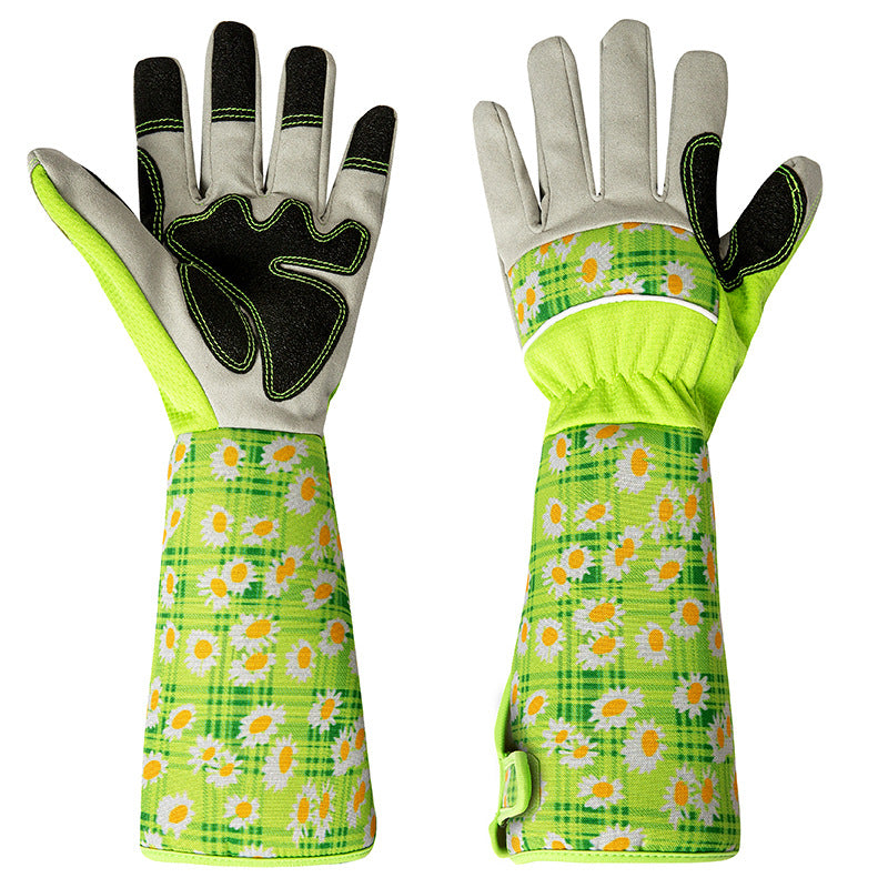 Green and gray gardening gloves with long cuffs, featuring a playful daisy pattern on a plaid background. The gloves have black grips on the palms and fingers for added traction.