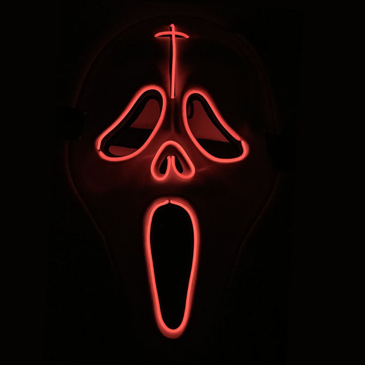 A glowing red neon mask resembling a screaming face with exaggerated features, set against a dark background.