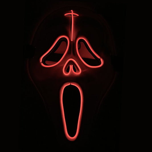 A glowing red neon mask resembling a screaming face with exaggerated features, set against a dark background.