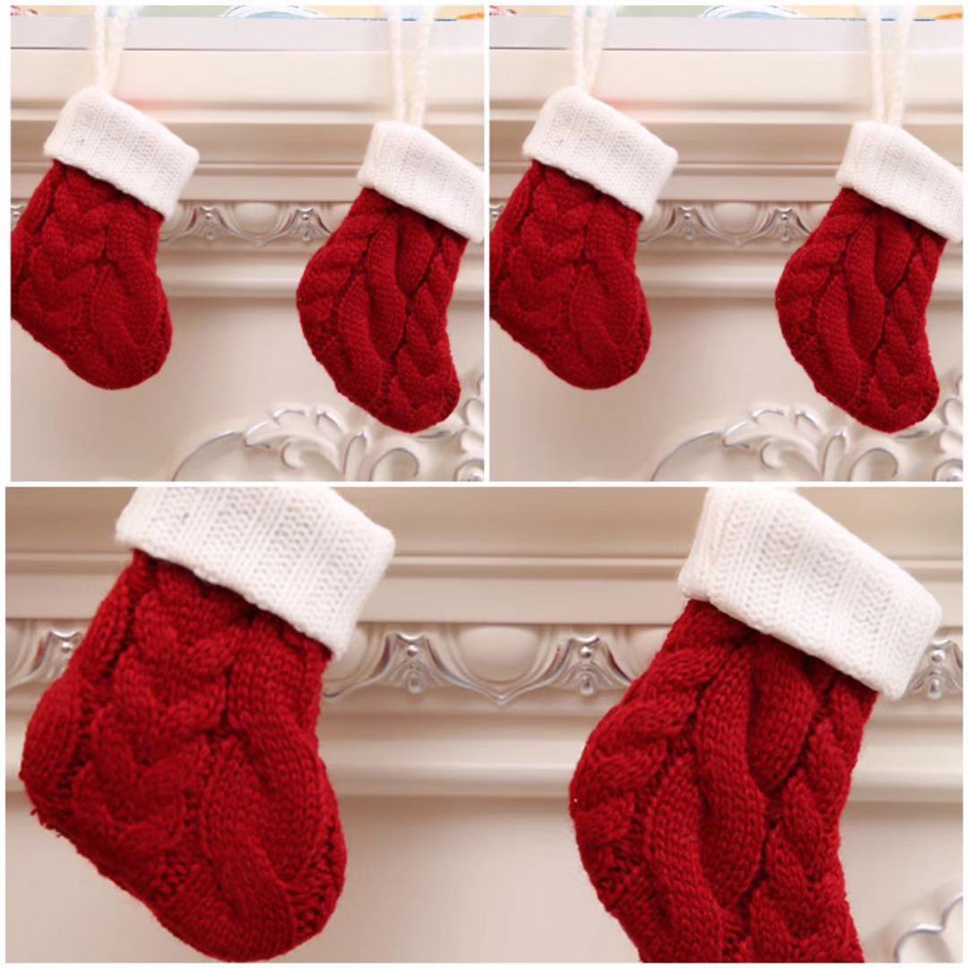 Three red knitted stockings with white cuffs hang on a decorative white mantel, each featuring a cable knit pattern.