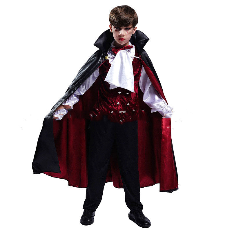 Young boy dressed as a vampire, wearing a black cape with a red lining, a white cravat, and a red vest, stands with arms extended, giving an intense look.